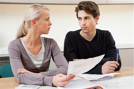 personal finance - Serious young couple doing home finances Stock Photo - Premium Royalty-Free, Code: 614-03359759