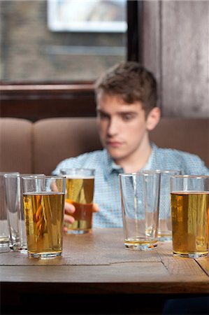 empty beer - Young man in bar Stock Photo - Premium Royalty-Free, Code: 614-03393408