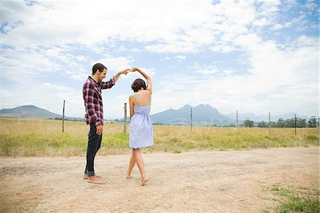 romance dance - Couple dancing in a field Stock Photo - Premium Royalty-Free, Code: 614-03393889