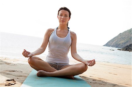 sitting yoga pose outside - Woman practicing yoga on a beach Stock Photo - Premium Royalty-Free, Code: 614-03420370
