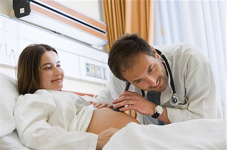 pregnant lady in hospital bed - Pregnant woman and doctor listening to stomach Stock Photo - Premium Royalty-Free, Code: 614-03454612
