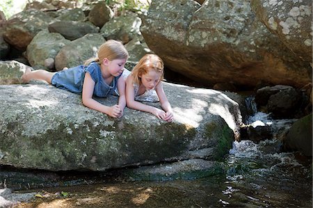 rock girl - Girls lying on rock by river Stock Photo - Premium Royalty-Free, Code: 614-03454701