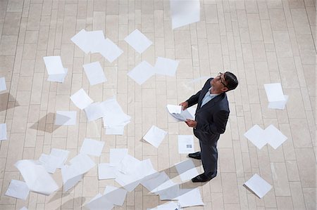 scattered photos - Businessman throwing papers Stock Photo - Premium Royalty-Free, Code: 614-03454745