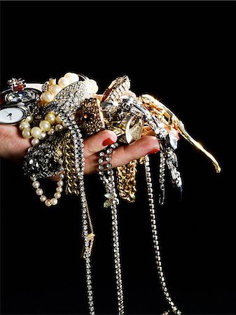 Woman holding jewelry Stock Photo - Premium Royalty-Free, Code: 614-03468737