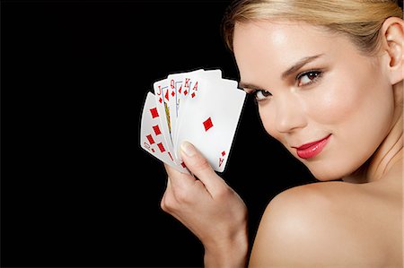 Young blonde woman playing cards Fotografie stock - Premium Royalty-Free, Codice: 614-03507557