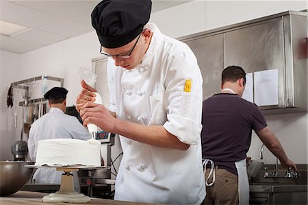 decorating - Making cake in commercial kitchen Stock Photo - Premium Royalty-Free, Code: 614-03551547