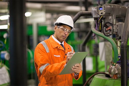safety glasses - Engineer in factory with clipboard Stock Photo - Premium Royalty-Free, Code: 614-03552222