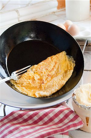 frying pan - Omelette in pan Stock Photo - Premium Royalty-Free, Code: 614-03576625