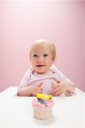 Baby girl with cupcake Stock Photo - Premium Royalty-Free, Code: 614-03576682