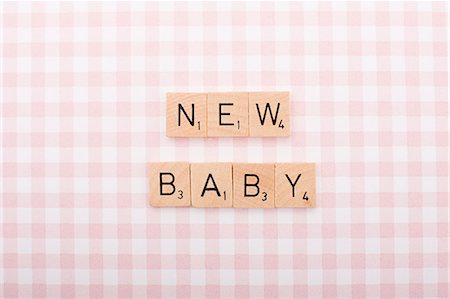 silhouette of new born baby - Game tile letters spelling new baby Stock Photo - Premium Royalty-Free, Code: 614-03577013