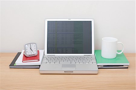 Laptop with alarm clock and mug Stock Photo - Premium Royalty-Free, Code: 614-03577082