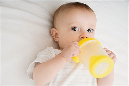 Baby drinking from bottle Stock Photo - Premium Royalty-Free, Code: 614-03648673