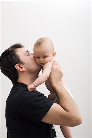 simsearch:614-03648671,k - Father holding baby son Foto de stock - Sin royalties Premium, Código: 614-03648687