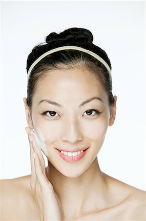 face washing - Young woman cleansing her face Stock Photo - Premium Royalty-Free, Code: 614-03649474