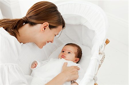 Mother with baby in bassinet Stock Photo - Premium Royalty-Free, Code: 614-03684111