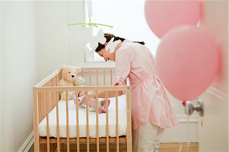 soft toy bed - Mother with baby in crib Stock Photo - Premium Royalty-Free, Code: 614-03684127