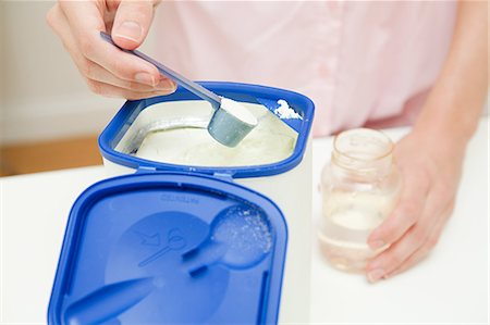 Close up of mother preparing baby formula Foto de stock - Royalty Free Premium, Número: 614-03684121