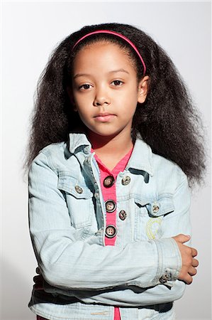 studio kid fashion - Girl in denim jacket with arms crossed Stock Photo - Premium Royalty-Free, Code: 614-03684826