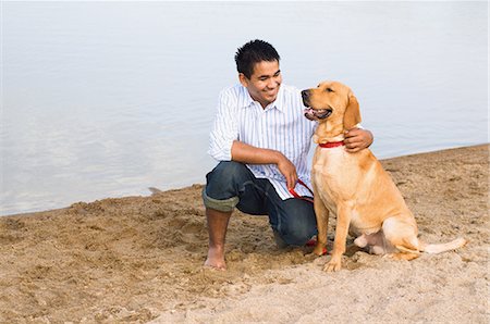 simsearch:614-03697070,k - Man and golden retriever at the beach Fotografie stock - Premium Royalty-Free, Codice: 614-03697069