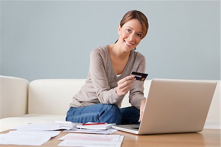 e-commerce - Young woman with credit card using laptop Stock Photo - Premium Royalty-Free, Code: 614-03697207