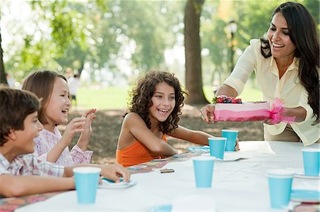 excited african american families - Children at birthday party with birthday cake Stock Photo - Premium Royalty-Free, Code: 614-03697225