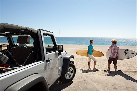 Two young men at the beach with surfboards Stock Photo - Premium Royalty-Free, Code: 614-03697662