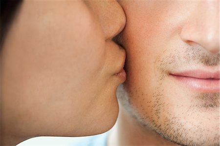 facial hair - Woman kissing man on cheek Stock Photo - Premium Royalty-Free, Code: 614-03697709