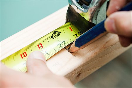 do it yourself - Woman measuring plank of wood and marking with pencil Stock Photo - Premium Royalty-Free, Code: 614-03747667
