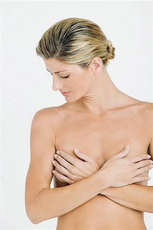 shy (people) - Young woman covering breasts Stock Photo - Premium Royalty-Free, Code: 614-03763559
