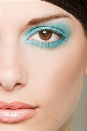 Young woman with turquoise eyeshadow Stock Photo - Premium Royalty-Free, Code: 614-03763716