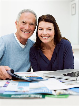 Mature couple using laptop to book vacation Stock Photo - Premium Royalty-Free, Code: 614-03763787