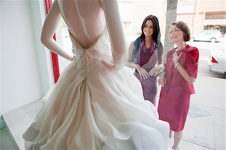 Mother and daughter looking at wedding dress in shop window Stock Photo - Premium Royalty-Free, Code: 614-03763890