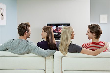 sitting on couch from back - Two couples watching television Stock Photo - Premium Royalty-Free, Code: 614-03784105