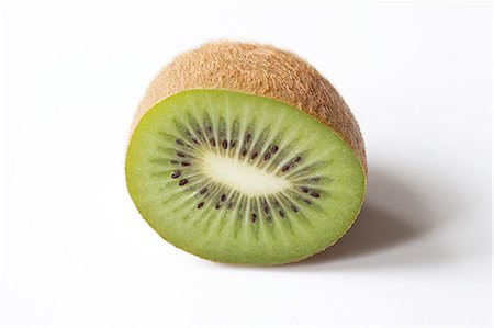 Half a kiwi on white background Foto de stock - Royalty Free Premium, Número: 614-03784167