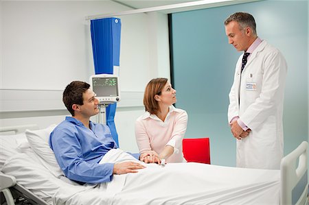 doctor and couple - Wife visiting husband in hospital, talking to doctor Foto de stock - Sin royalties Premium, Código: 614-03783628