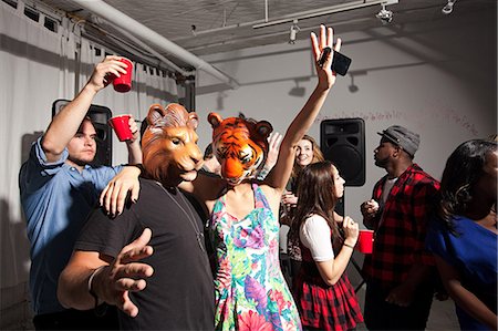 party and afro american - People wearing lion and tiger masks dancing at party Stock Photo - Premium Royalty-Free, Code: 614-03818471