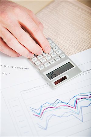 Office worker using calculator Fotografie stock - Premium Royalty-Free, Codice: 614-03818858