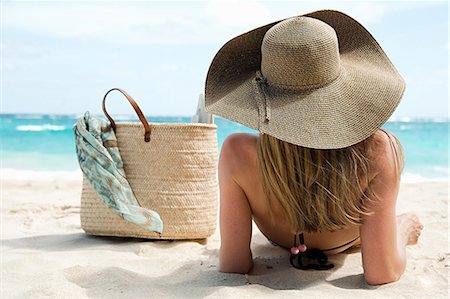 sunhat - Woman lying on sandy beach, Mustique, Grenadine Islands Stock Photo - Premium Royalty-Free, Code: 614-03902665