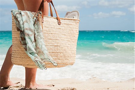 Woman carrying beach bag, Mustique, Grenadine Islands Stock Photo - Premium Royalty-Free, Code: 614-03902671