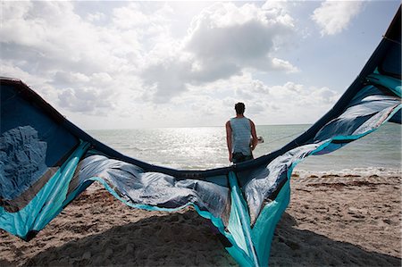 Kitesurfer on beach Stock Photo - Premium Royalty-Free, Code: 614-03903020