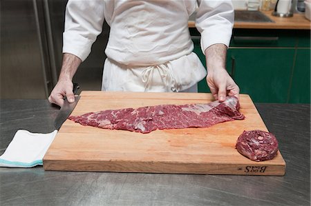 person cutting food on cutting boards - Butcher preparing beef tenderloin Foto de stock - Sin royalties Premium, Código: 614-03903588