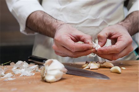 Chef adding peeling garlic Stock Photo - Premium Royalty-Free, Code: 614-03903614