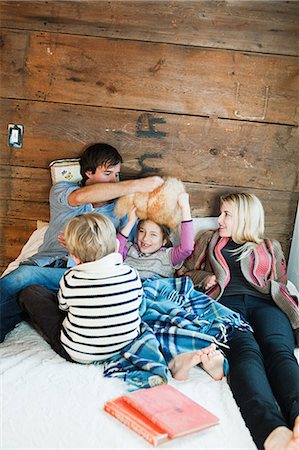 rustic cabins - Family playing on bed Stock Photo - Premium Royalty-Free, Code: 614-03981314