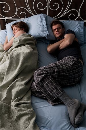 funny pictures of people sleeping - Young stealing blankets from young man Stock Photo - Premium Royalty-Free, Code: 614-03981520