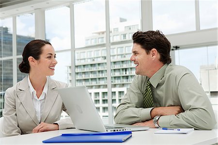 simsearch:614-03981680,k - Businessman and businesswoman meeting in office with laptop Stock Photo - Premium Royalty-Free, Code: 614-03981656