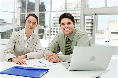 simsearch:614-03981680,k - Businessman and businesswoman meeting in office with laptop Stock Photo - Premium Royalty-Free, Code: 614-03981658