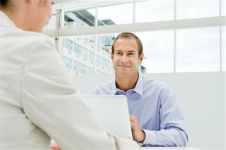 simsearch:614-03981680,k - Businessman and businesswoman meeting in office Stock Photo - Premium Royalty-Free, Code: 614-03981673