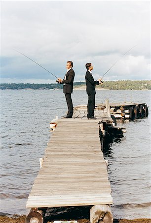 simsearch:6102-03859327,k - Two men dressed in suits fishing from a bridge. Stock Photo - Premium Royalty-Free, Code: 6102-03748232
