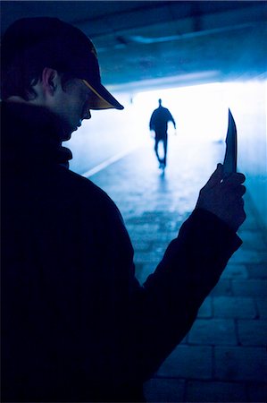 A man with a knife in a viaduct. Stock Photo - Premium Royalty-Free, Code: 6102-03749497