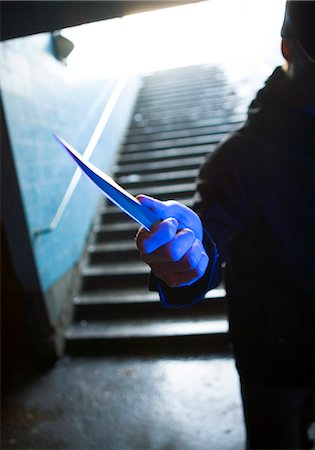 stairs on tunnel - A man with a knife in his hand. Stock Photo - Premium Royalty-Free, Code: 6102-03749498